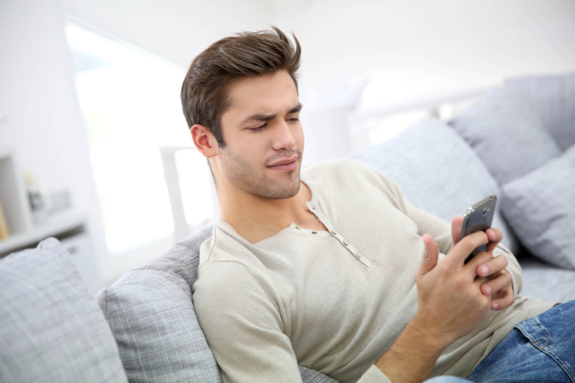 Man looking at his phone with intensity.